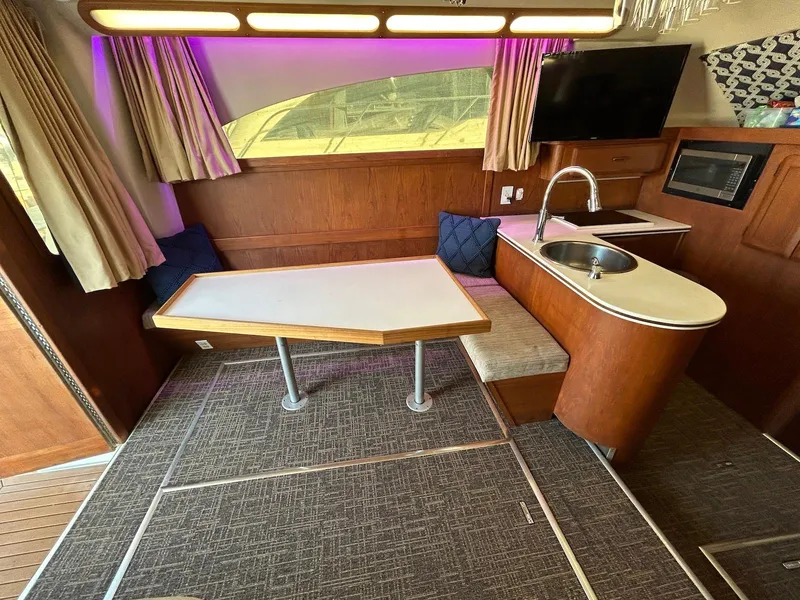 Slide: The Image of Interior of 1993 Luhrs Tournament 380 Convertible yacht with table, sink, and TV. - 15