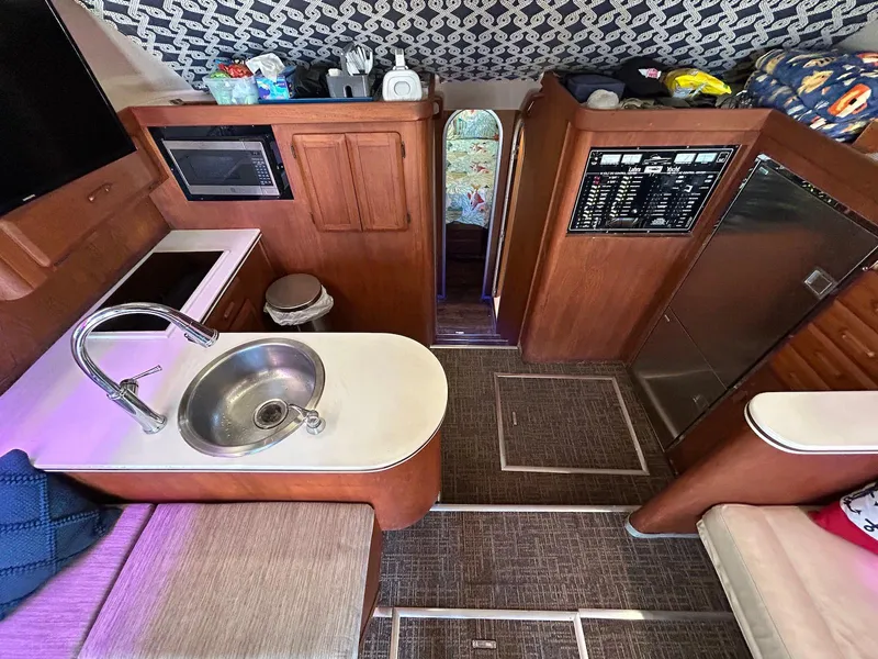 Slide: The Image of 1993 Luhrs Tournament 380 Convertible yacht interior with kitchen, sink, and control panel. - 16