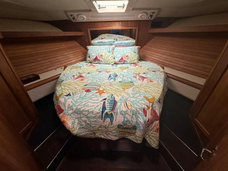 Slide: The Image of 1993 Luhrs Tournament 380 Convertible cabin with colorful marine-themed bedding. - 17