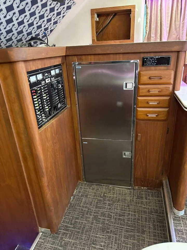 Slide: The Image of 1993 Luhrs Tournament 380 Convertible yacht interior with wood cabinetry and stainless steel fridge. - 18