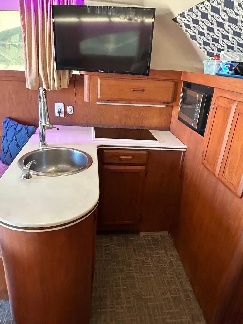 Slide: The Image of 1993 Luhrs Tournament 380 Convertible yacht kitchen with sink, stove, and microwave. - 19