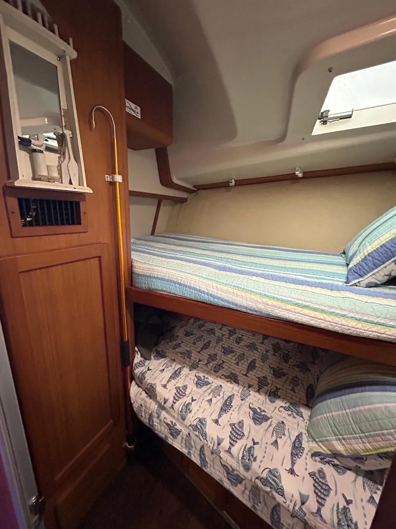 Slide: The Image of 1993 Luhrs Tournament 380 Convertible cabin with cozy bunk beds and nautical decor. - 20