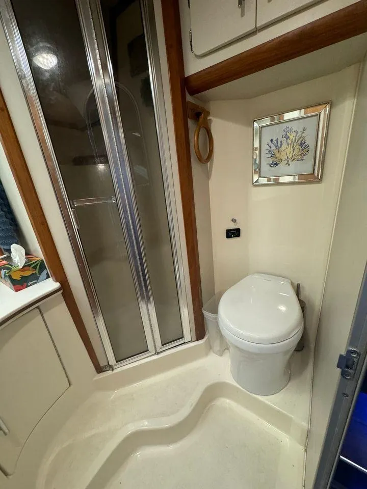 Slide: The Image of 1993 Luhrs Tournament 380 Convertible bathroom with shower and toilet. - 21