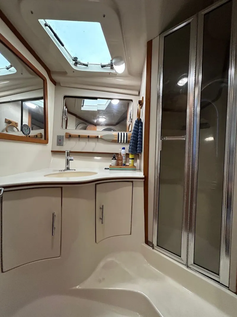 Slide: The Image of 1993 Luhrs Tournament 380 Convertible bathroom with skylight and modern fixtures. - 22