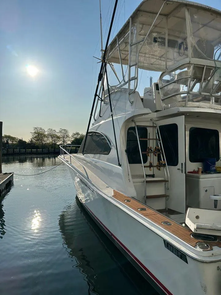 Slide: The Image of 1993 Luhrs Tournament 380 Convertible yacht docked under a bright sun. - 3