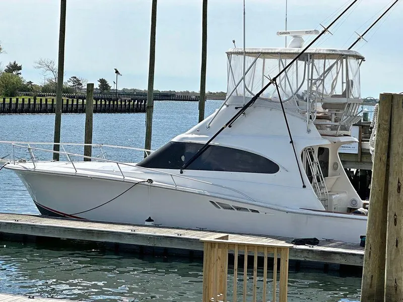 Slide: The Image of 1993 Luhrs Tournament 380 Convertible yacht docked by the water. - 5