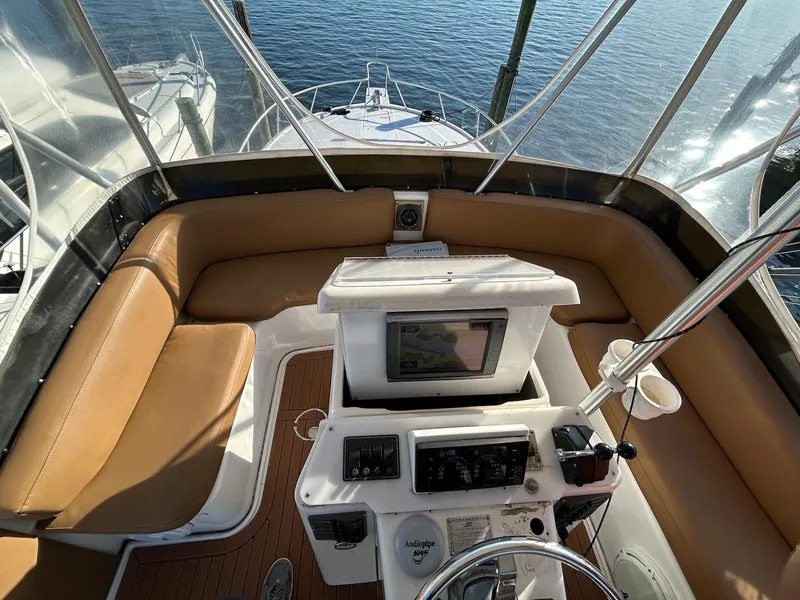 Slide: The Image of 1993 Luhrs Tournament 380 Convertible helm with tan seating and navigation equipment. - 8