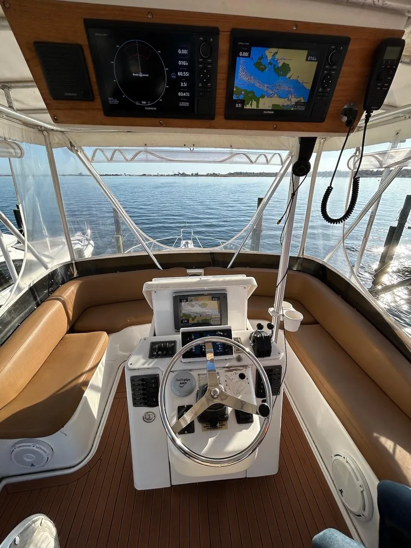 Slide: The Image of 1993 Luhrs Tournament 380 Convertible boat helm with navigation equipment and seating. - 9