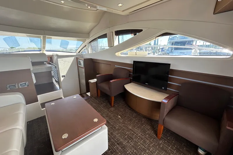 Slide: The Image of Luxurious interior of 2012 Sea Ray 450 Sedan Bridge yacht with seating and TV. - 11