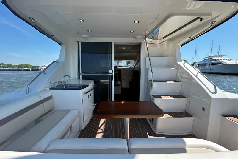 Slide: The Image of Interior view of 2012 Sea Ray 450 Sedan Bridge yacht with seating and stairs. - 2