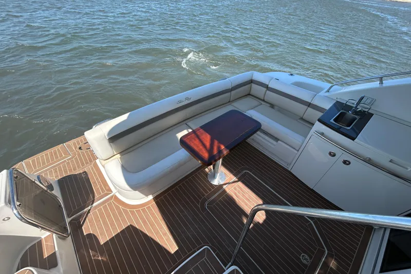 Slide: The Image of Luxurious 2012 Sea Ray 450 Sedan Bridge yacht deck with seating and table. - 4