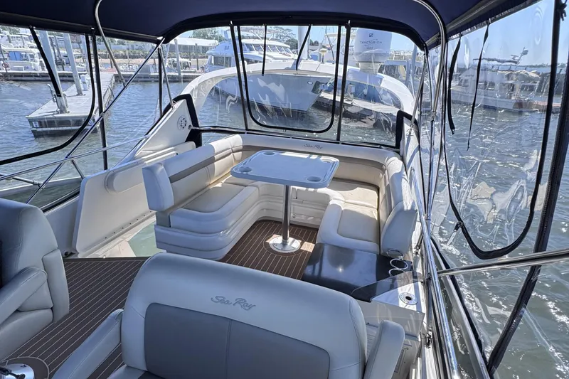 Slide: The Image of Luxurious 2012 Sea Ray 450 Sedan Bridge yacht interior with seating and table, docked at marina. - 5