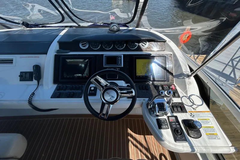 Slide: The Image of Cockpit of 2012 Sea Ray 450 Sedan Bridge with advanced navigation controls and steering wheel. - 8
