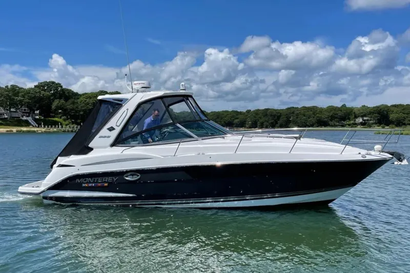 The Image of 2021 Monterey 335 Sport Yacht cruising on a sunny day with scenic background. - 0