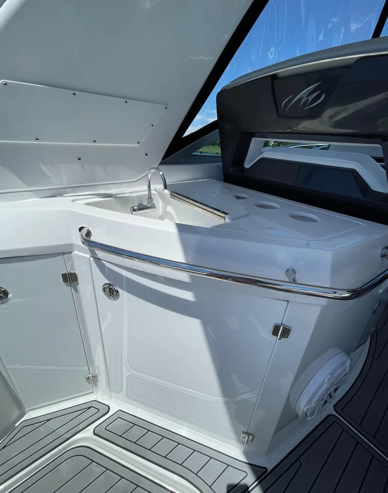 Slide: The Image of Interior of 2021 Monterey 335 Sport Yacht with sink and storage. - 11