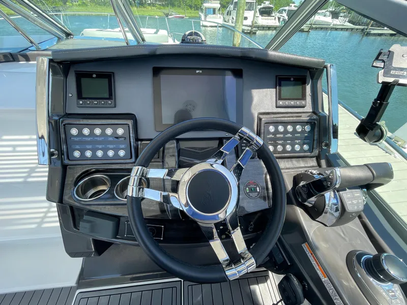 Slide: The Image of 2021 Monterey 335 Sport Yacht helm at the marina. - 15