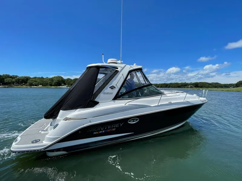 Slide: The Image of Monterey 335 Sport Yacht 2021 on calm water under clear sky. - 2