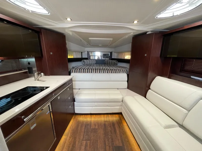 Slide: The Image of Interior of 2021 Monterey 335 Sport Yacht with modern kitchen and sleeping area. - 22