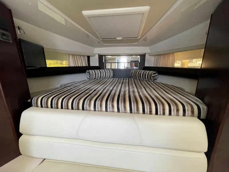 Slide: The Image of Interior of 2021 Monterey 335 Sport Yacht with striped bedding. - 27