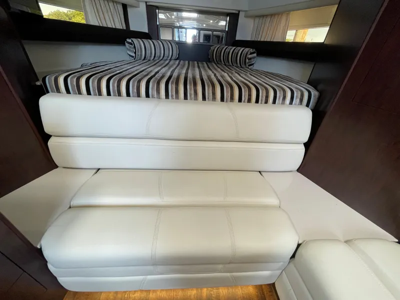 Slide: The Image of Interior of 2021 Monterey 335 Sport Yacht with striped bedding. - 28