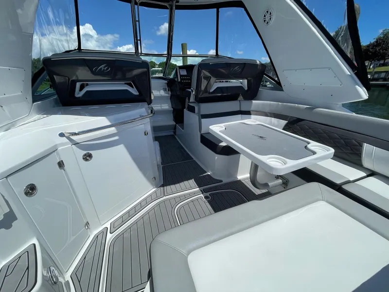 Slide: The Image of Interior of 2021 Monterey 335 Sport Yacht with seating area and table. - 7