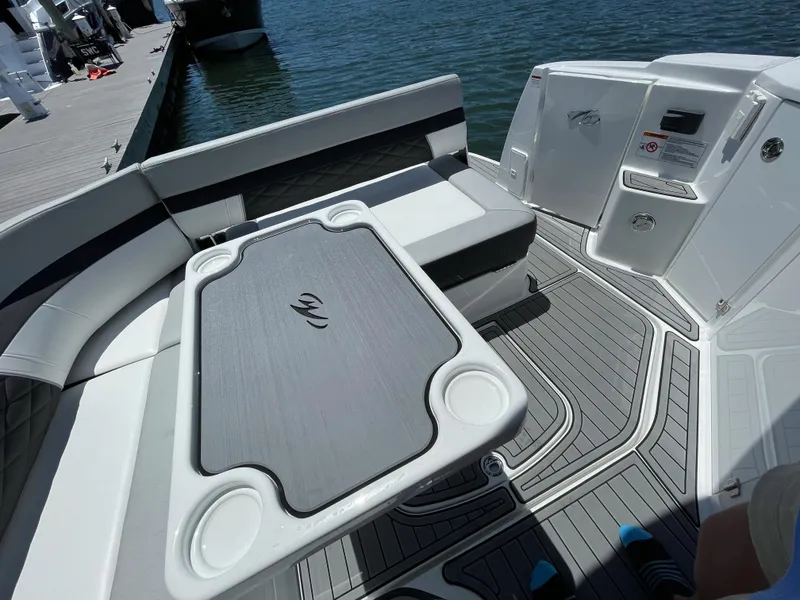 Slide: The Image of Interior of 2021 Monterey 335 Sport Yacht with table and seating area. - 9
