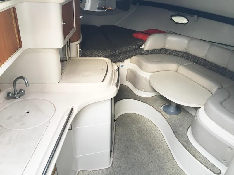 Slide: The Image of Interior of a 1999 Chris-Craft 320 Express Cruiser with kitchen and seating area. - 18