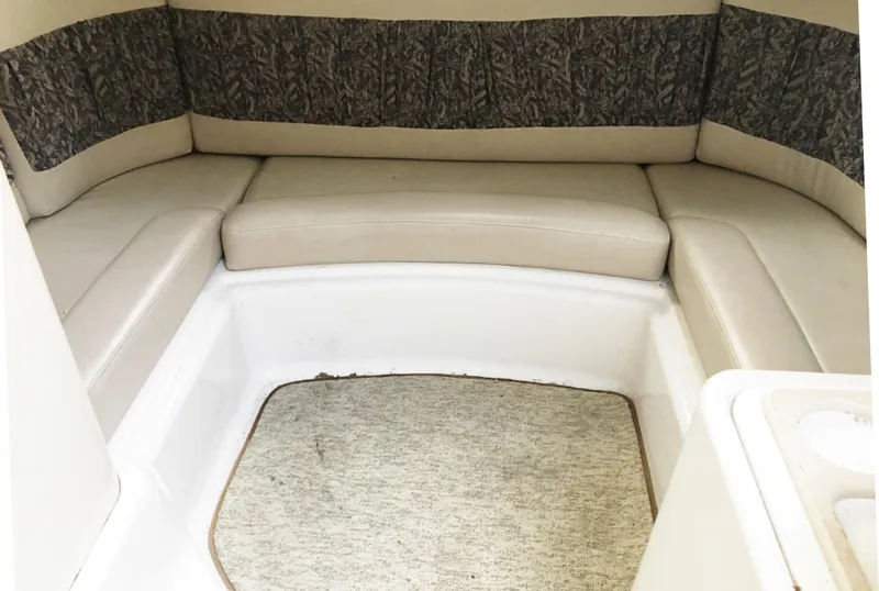 Slide: The Image of Interior of 1999 Chris-Craft 320 Express Cruiser with cushioned seating. - 23