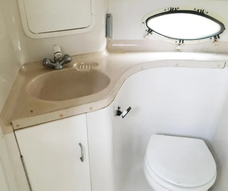 Slide: The Image of 1999 Chris-Craft 320 Express Cruiser interior, bathroom with sink and toilet. - 24