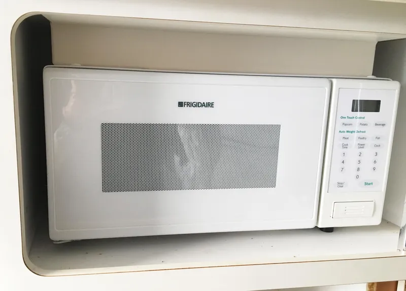 Slide: The Image of White Frigidaire microwave oven installed in a shelf. - 27