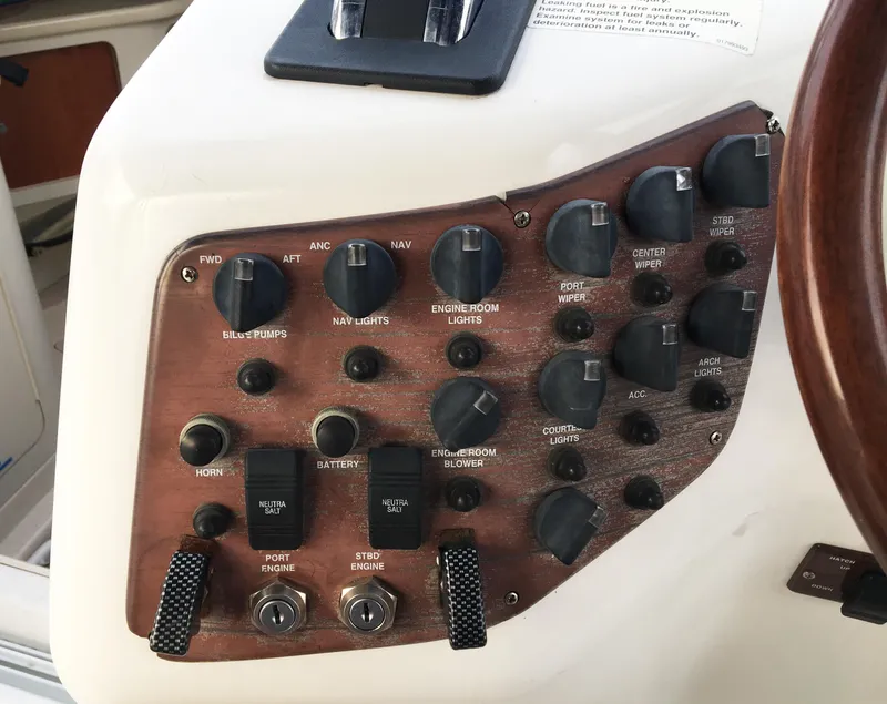 Slide: The Image of Dashboard of a 1999 Chris-Craft 320 Express Cruiser with switches and knobs. - 32