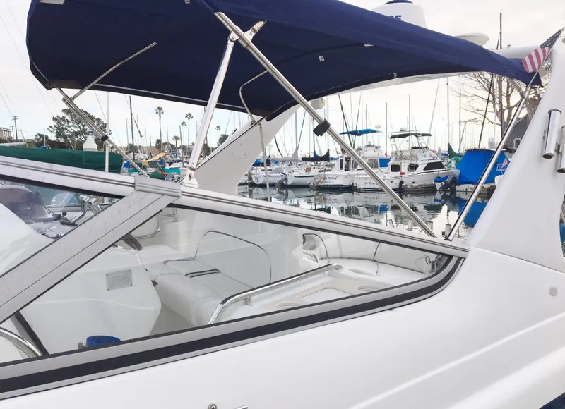 Slide: The Image of 1999 Chris-Craft 320 Express Cruiser docked with blue canopy. - 4