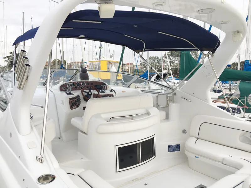 Slide: The Image of Interior of a 1999 Chris-Craft 320 Express Cruiser with blue canopy. - 9