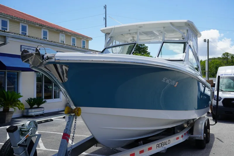 The Image of 2020 Edgewater 262CX Crossover boat on trailer, parked outdoors. - 0