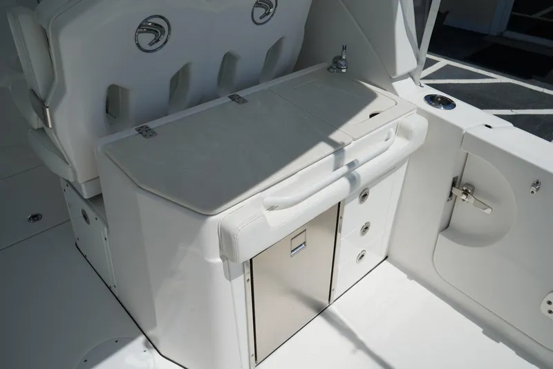 Slide: The Image of 2020 Edgewater 262CX Crossover boat interior with seating and storage compartments. - 10