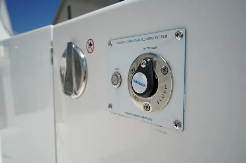 Slide: The Image of Close-up of 2020 Edgewater 262CX Crossover's Reverso outboard flushing system. - 12