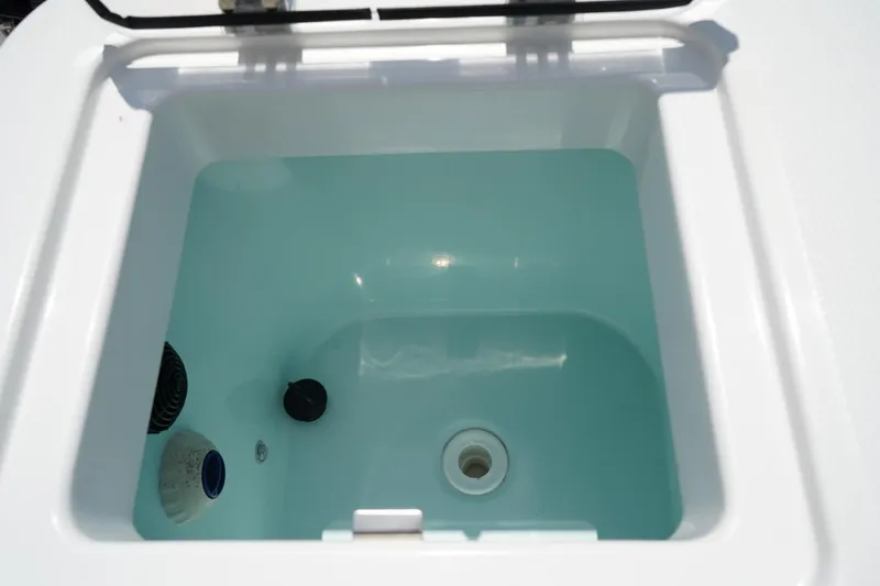 Slide: The Image of Livewell compartment in 2020 Edgewater 262CX Crossover boat, filled with water. - 15
