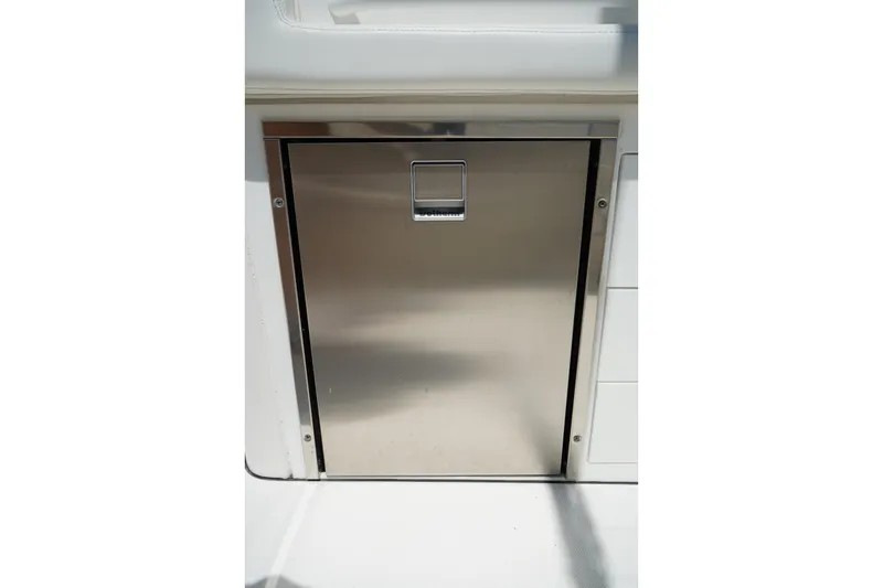 Slide: The Image of Stainless steel storage compartment on 2020 Edgewater 262CX Crossover boat. - 17