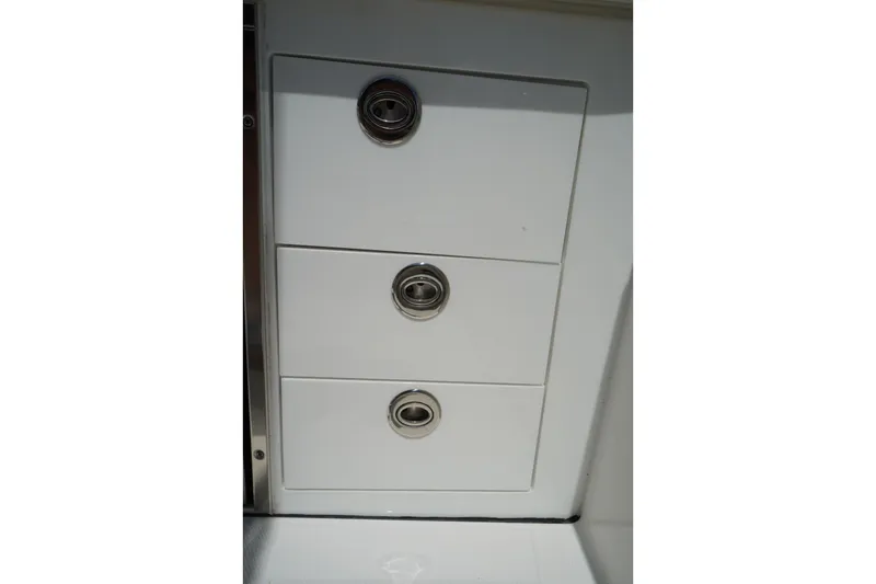Slide: The Image of White storage drawers on a 2020 Edgewater 262CX Crossover boat. - 18