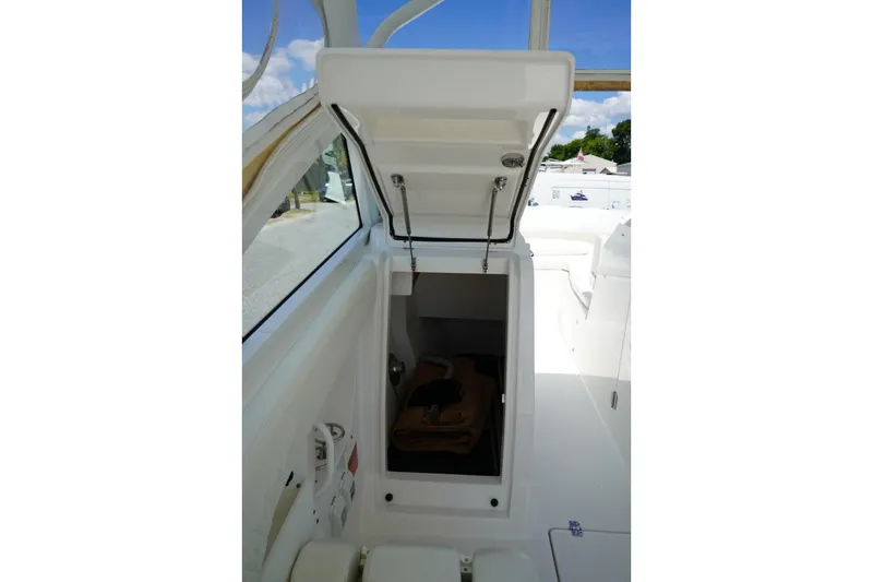 Slide: The Image of 2020 Edgewater 262CX Crossover boat interior with open storage compartment. - 21