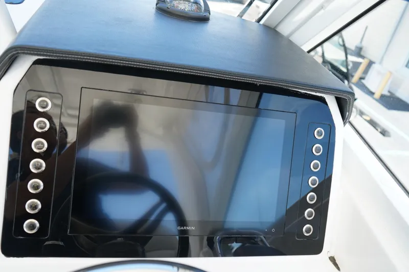 Slide: The Image of Dashboard of 2020 Edgewater 262CX Crossover boat with Garmin display. - 25