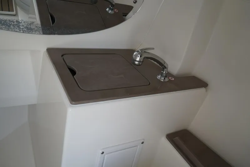 Slide: The Image of 2020 Edgewater 262CX Crossover boat interior sink with faucet and countertop. - 30