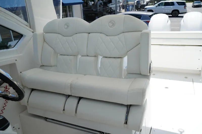 Slide: The Image of Luxurious seating on 2020 Edgewater 262CX Crossover boat, featuring elegant white upholstery. - 31