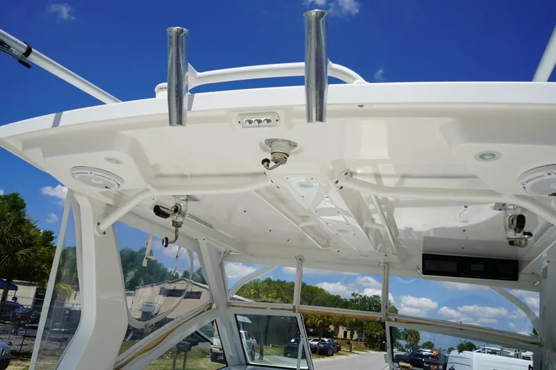 Slide: The Image of 2020 Edgewater 262CX Crossover boat's helm station with blue sky background. - 32