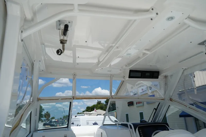Slide: The Image of Interior view of 2020 Edgewater 262CX Crossover boat, showcasing helm and overhead features. - 33