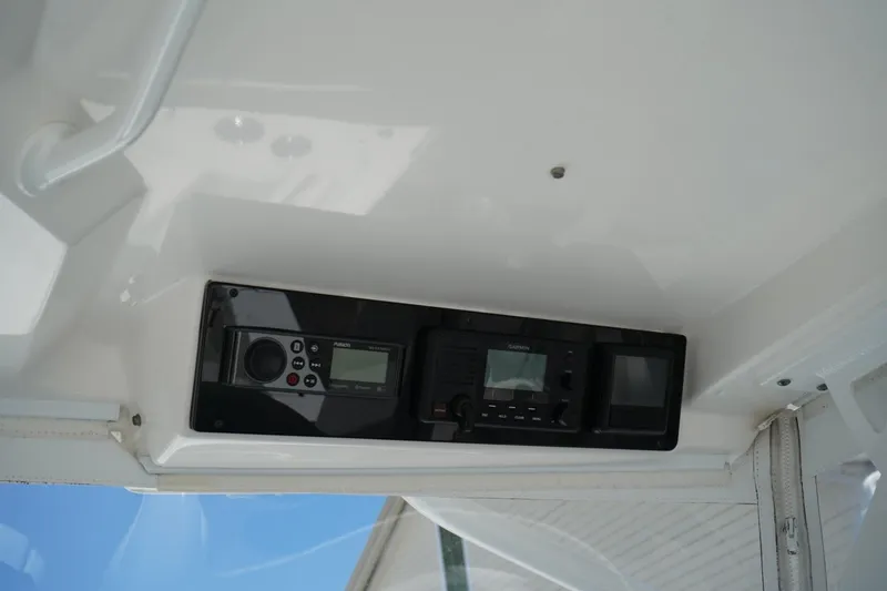 Slide: The Image of 2020 Edgewater 262CX Crossover boat dashboard with electronic controls and navigation system. - 34
