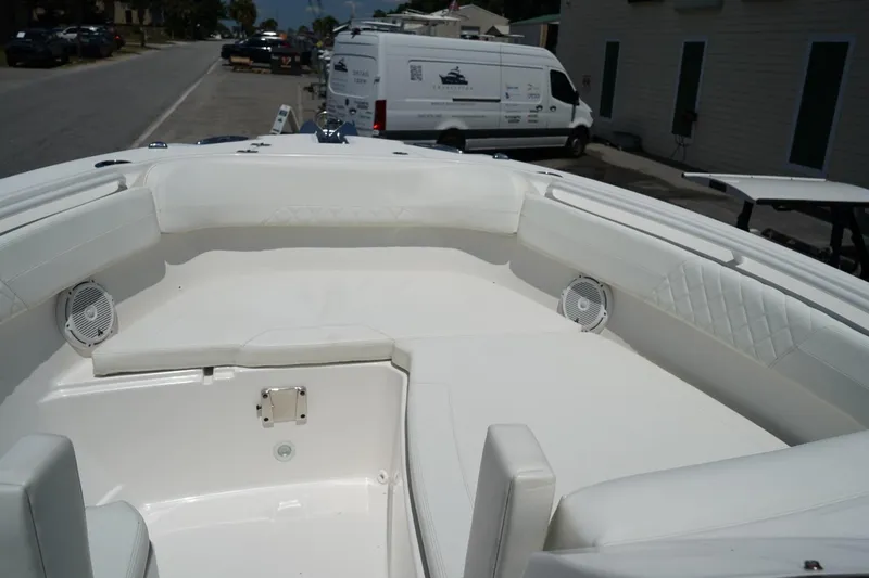 Slide: The Image of Bow seating area of a 2020 Edgewater 262CX Crossover boat, featuring white upholstery. - 36