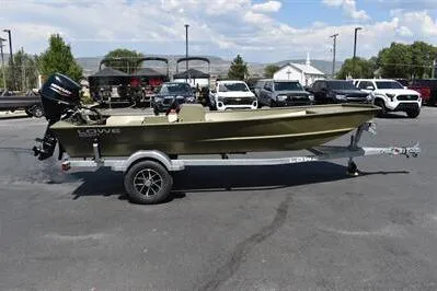 The Image of 2025 Lowe L1652MT Jon boat on trailer, parked in lot with cars and trees. - 0