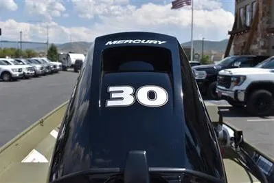Slide: The Image of 2025 Lowe L1652MT Jon boat with Mercury 30 horsepower engine in parking lot. - 10