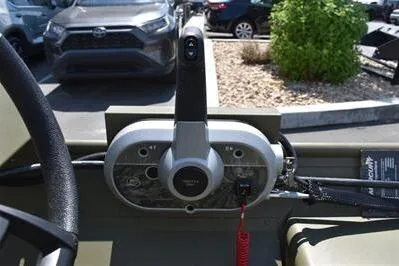 Slide: The Image of 2025 Lowe L1652MT Jon boat control panel with steering wheel and throttle lever. - 15